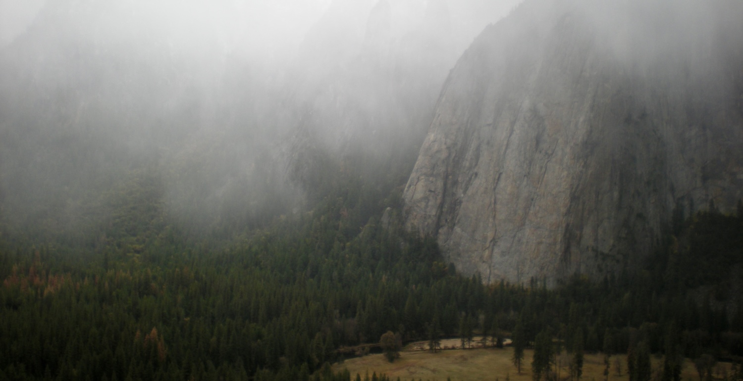 Yosemite Valley view of Middle Cathedral and Higher Cathedral from El Capitan, with a low fog covering Yosemite Valley.